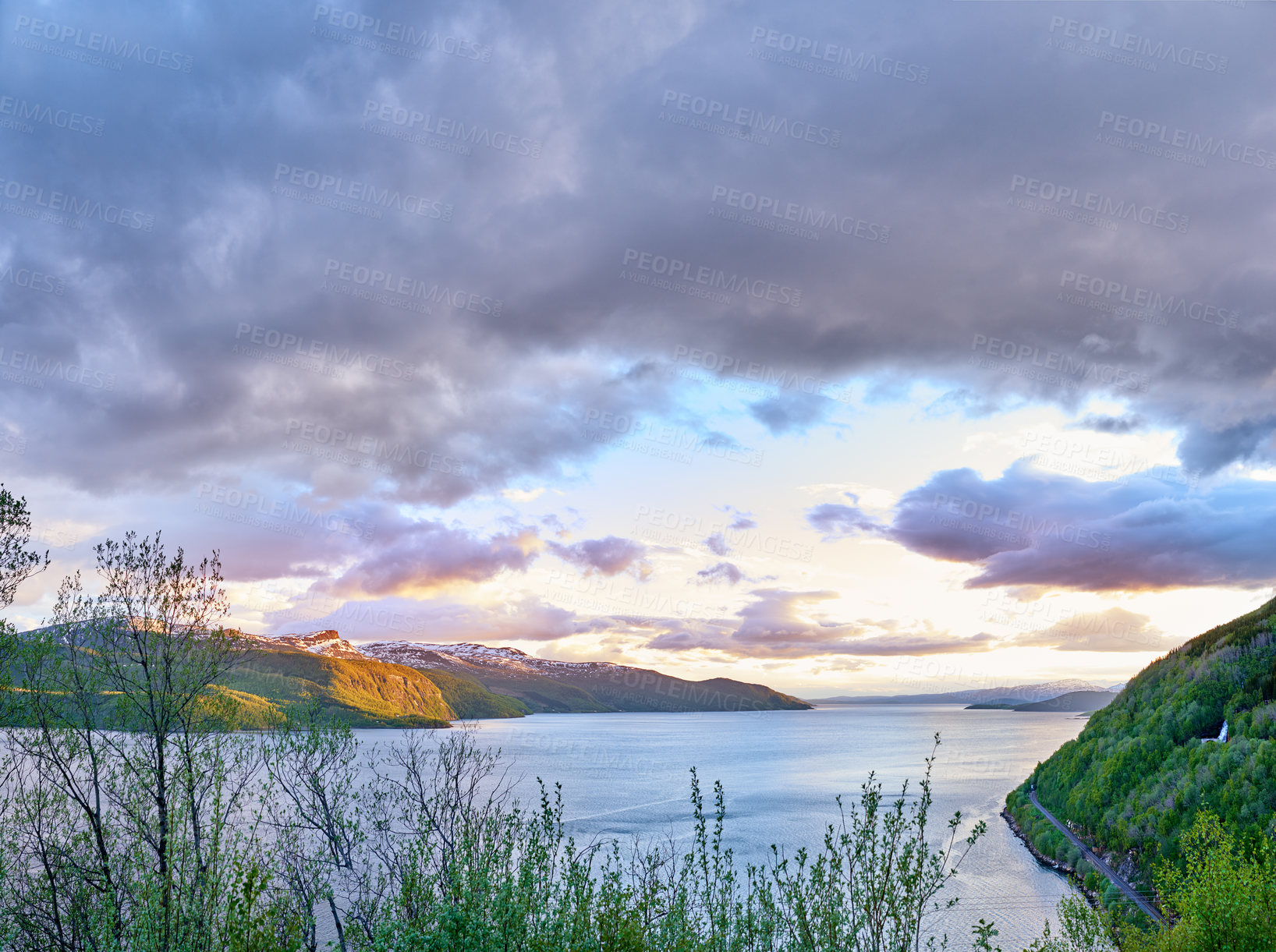 Buy stock photo Scenic view of a lake, ocean or sea with cloudy sky at sunset and copy space.Uncultivated trees, bushes, shrubs around a bay of water in Norway. Landscape of calm, serene, peaceful, quiet nature pond