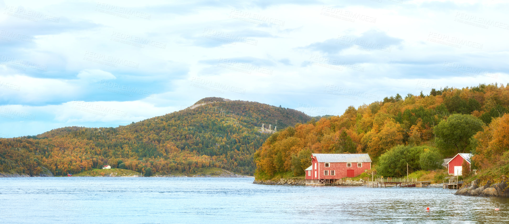 Buy stock photo Scenic view of a lake house with uncultivated trees, bushes, shrubs around a bay of water in Norway. Landscape of wild flora growing in remote, calm, serene and quiet isolated residential countryside