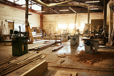 Buy stock photo Still life shot of the machinery and piles of wood inside a carpentry workshop