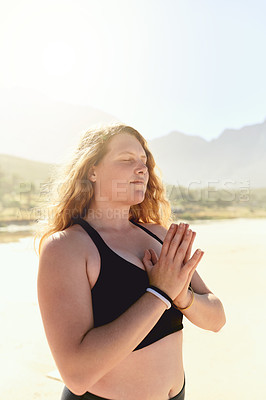 Buy stock photo Cropped shot of a beautiful young woman practising yoga on the beach