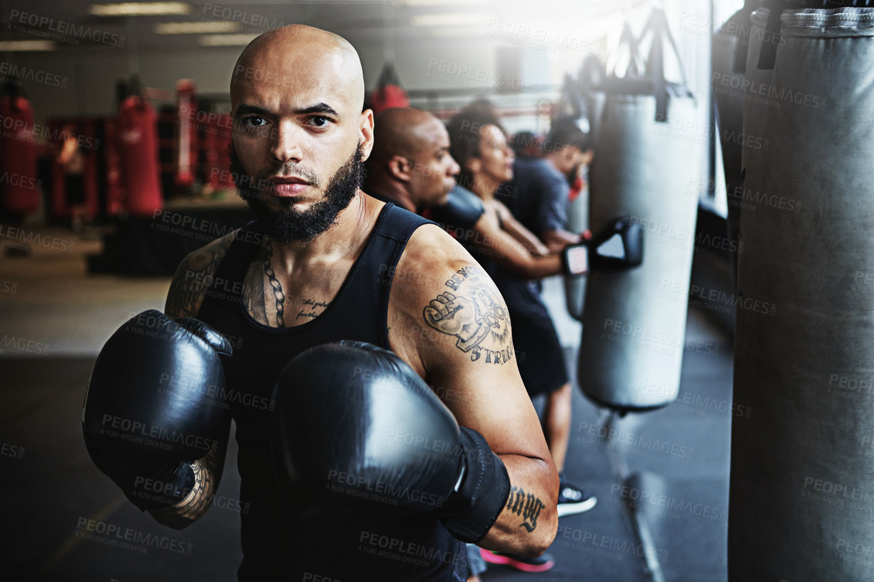 Buy stock photo Shot of a male boxer training at the gym