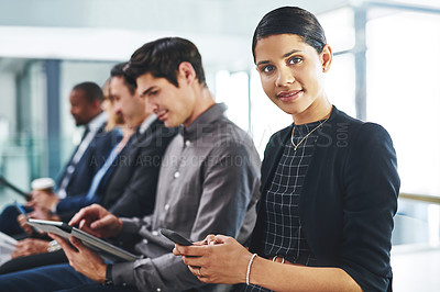 Buy stock photo Cropped shot of an attractive young businesswoman using a smartphone while sitting in line for an interview in a modern office
