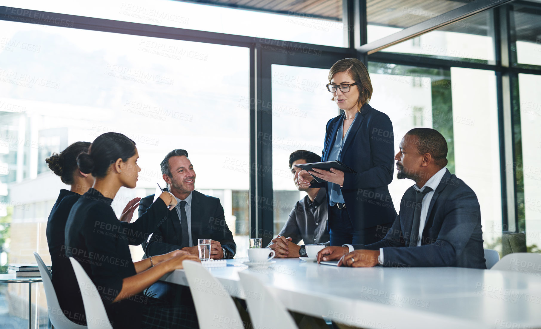 Buy stock photo Cropped shot of a diverse group of businesspeople having a meeting in a boardroom