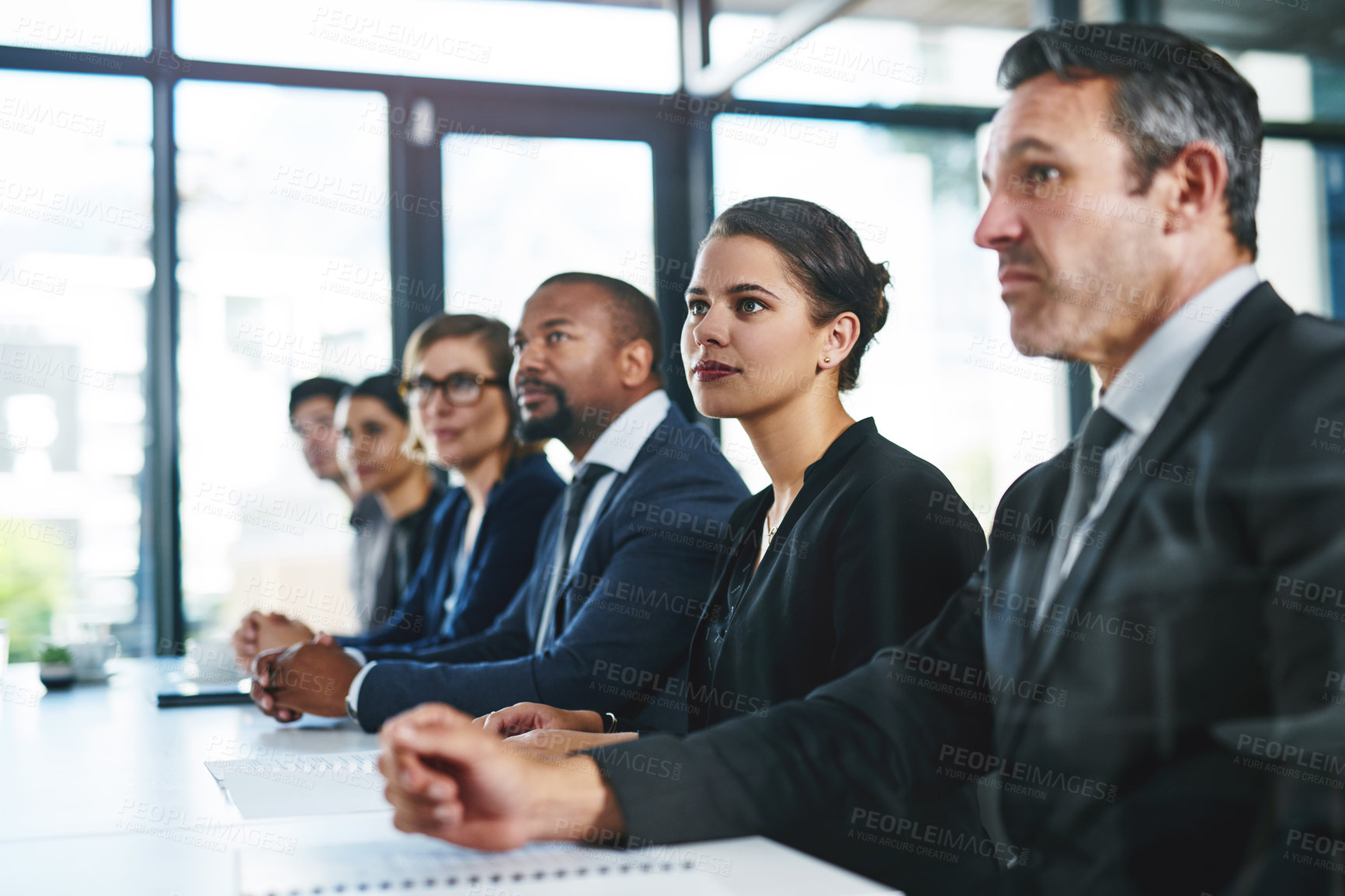 Buy stock photo Cropped shot of a diverse group of young businesspeople attending a conference
