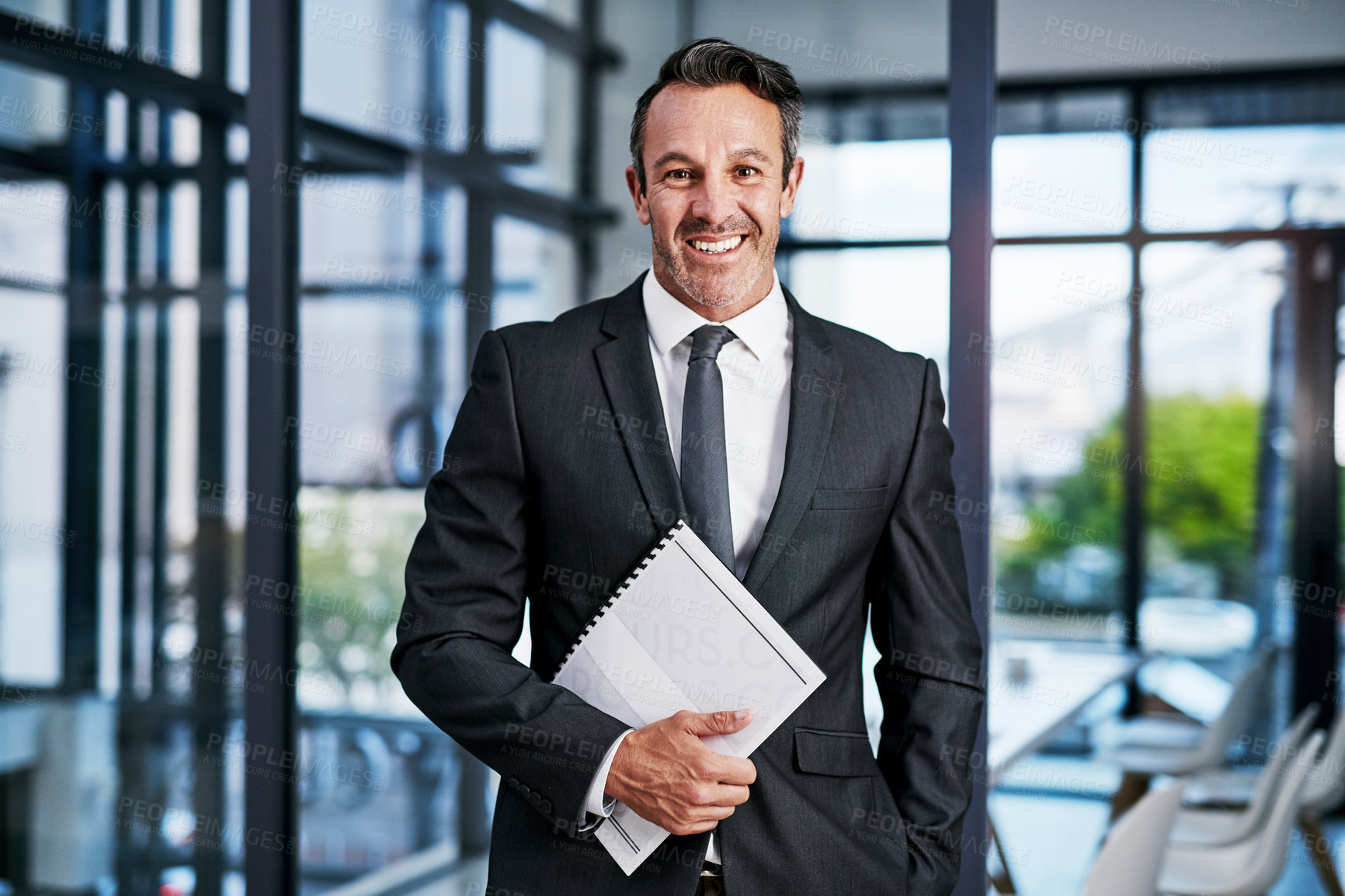 Buy stock photo Cropped portrait of a handsome mature businessman smiling while standing in a modern office