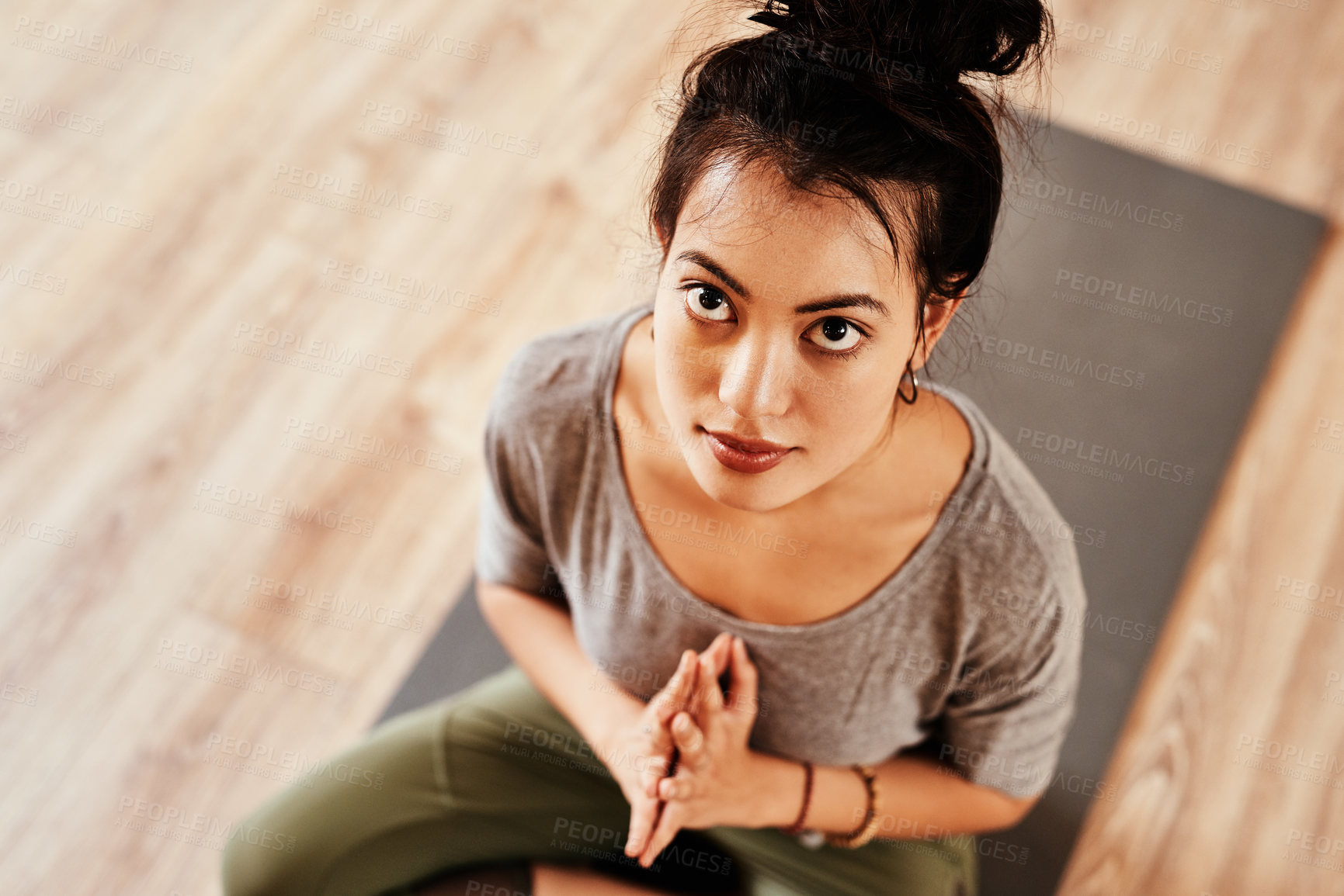 Buy stock photo Shot of a young woman meditating during a yoga session