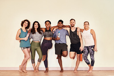 Buy stock photo Shot of a group of young men and women hanging out in yoga class 
