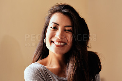 Buy stock photo Portrait of a beautiful young woman posing against a brown background