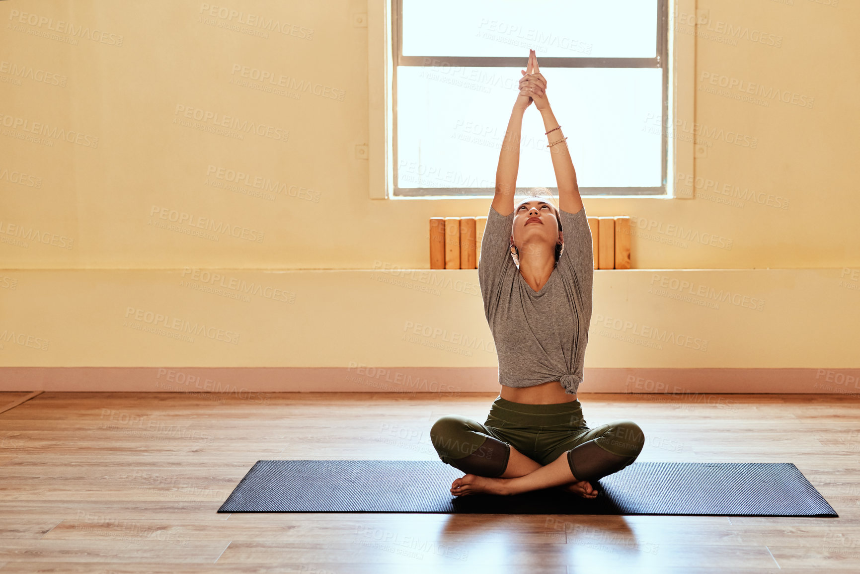 Buy stock photo Shot of a young women meditating during a yoga session