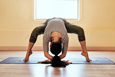 Buy stock photo Shot of a young woman practicing an advanced yoga position