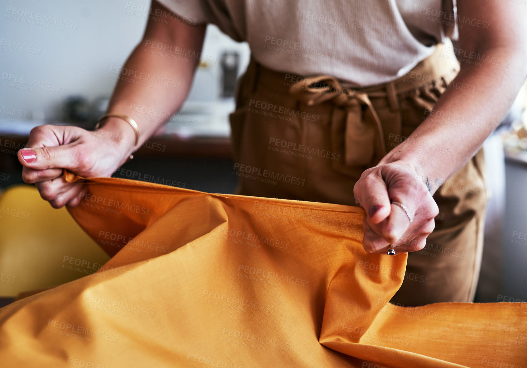 Buy stock photo Cropped shot of an unrecognizable designer working with fabric in her workshop