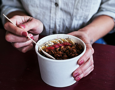 Buy stock photo Cropped shot of an unrecognizable woman having a bowl of granola