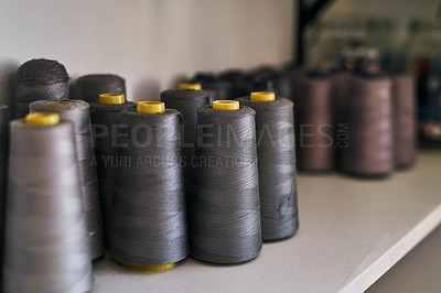 Buy stock photo Cropped shot of spools of thread on a shelf