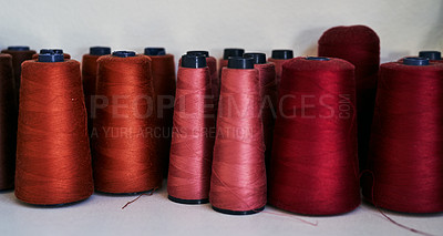 Buy stock photo Cropped shot of spools of thread in a workshop