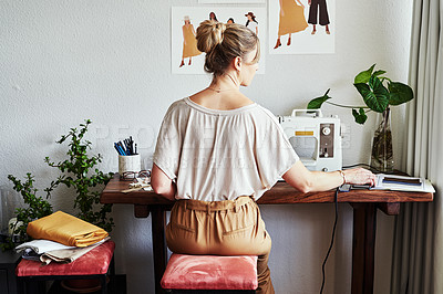 Buy stock photo Rearview shot of a fashion designer working in her workshop