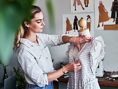 Buy stock photo Fashion, sustainable business and woman designer with mannequin, measuring tape and creative startup. Focus, creativity and tailor with dress on doll, eco friendly design on clothes in textile studio