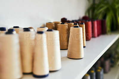 Buy stock photo Cropped shot of spools of thread on a shelf