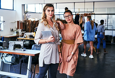Buy stock photo Cropped shot of two fashion designers working together in a workshop