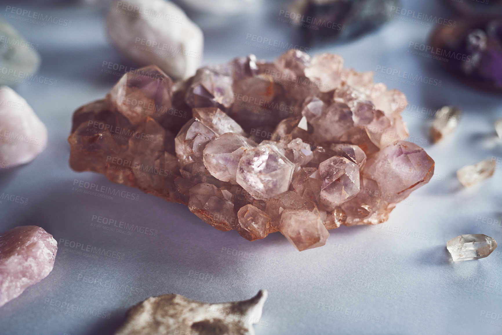 Buy stock photo Closeup of a beautiful crystal placed on a table with other different types of crystals during the day
