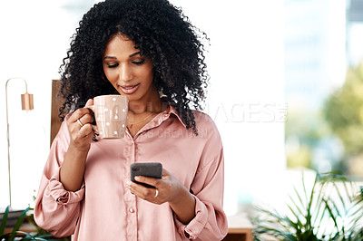 Buy stock photo Shot of a young businesswoman having coffee and using a smartphone in a modern office