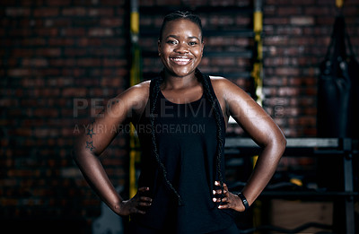 Buy stock photo Cropped portrait of an attractive young female athlete standing with her hands on her hips in the gym