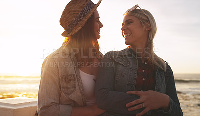 Buy stock photo Shot of an affectionate and happy young couple bonding and spending the day together outdoors near the beach