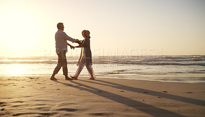 Buy stock photo Full length shot of an affectionate senior couple dancing together at the beach at sunset