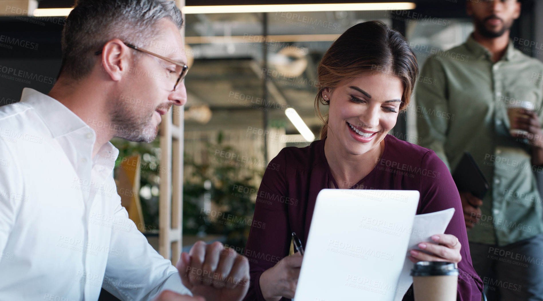 Buy stock photo Shot of a businessman and businesswoman using a laptop and having a discussion in a modern office