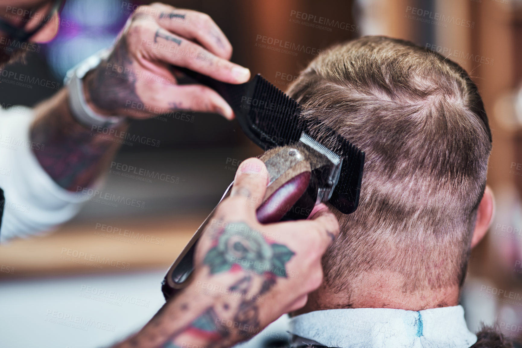Buy stock photo Cropped shot of an unrecognizable man getting a haircut at a barbershop