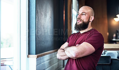 Buy stock photo Cropped shot of a handsome young barber posing with his arms folded inside his barbershop