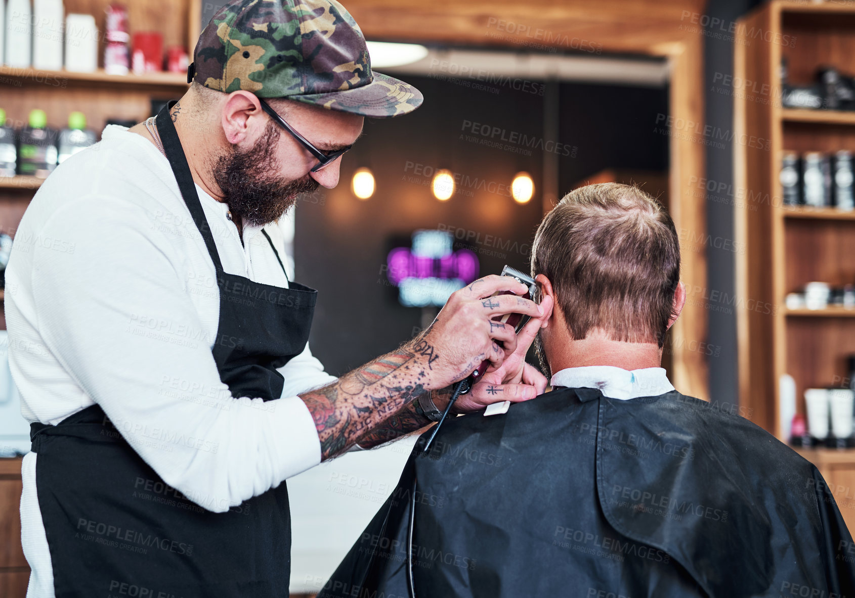 Buy stock photo Hair care, client and man in barbershop with machine, cut and tools for trendy hairstyle at small business. Style, barber and customer in chair for grooming service, creative haircut and clean trim.