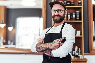 Buy stock photo Portrait of a handsome young barber posing with his arms folded inside his barbershop