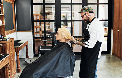 Buy stock photo Cropped shot of an attractive young woman getting her hair styled and treated by a hairdresser at a salon