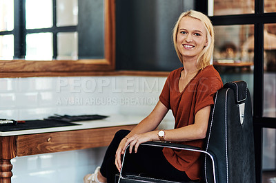 Buy stock photo Portrait of an attractive young hair dresser sitting on a chair inside her salon