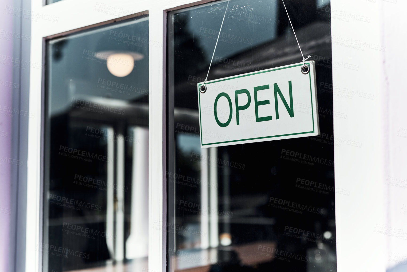 Buy stock photo Still life shot of an open sign hanging on the window of a barbershop