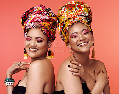 Buy stock photo Fashion, friends and African women with beauty on orange background with cosmetics, makeup and accessories. Glamour, luxury and face of female people with exotic jewelry, traditional style and scarf