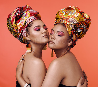 Buy stock photo Fashion, beauty and African women hug on orange background with cosmetics, makeup and accessories. Glamour, luxury and female people with exotic jewelry, traditional style and head scarf in studio