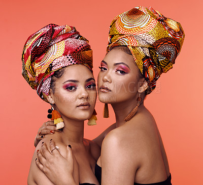 Buy stock photo Fashion, beauty and portrait of African women on orange background with cosmetics, makeup and accessories. Glamour, luxury and face of female people hug in exotic jewelry, traditional style and scarf