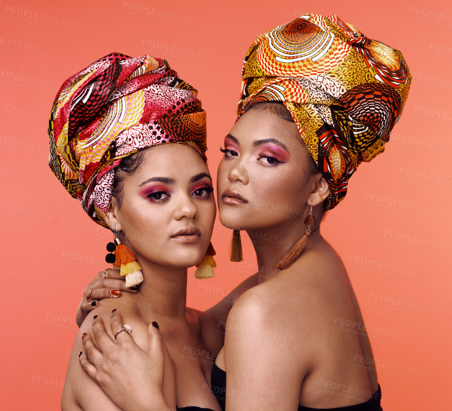 Buy stock photo Fashion, beauty and portrait of African women on orange background with cosmetics, makeup and accessories. Glamour, luxury and face of female people hug in exotic jewelry, traditional style and scarf