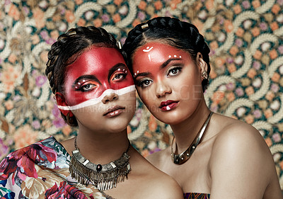 Buy stock photo Culture, makeup and portrait of girls, traditional and art on face, color and respect for religion. Pattern, background and twins of women, proud and confident with paint, red and together or beauty