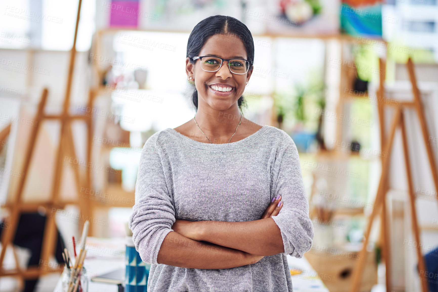 Buy stock photo Cropped shot of a beautiful young woman smiling at the camera in a art studio
