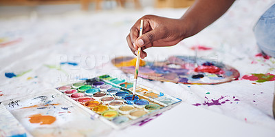 Buy stock photo Cropped shot of an unrecognizable woman using a paintbrush and paint palette