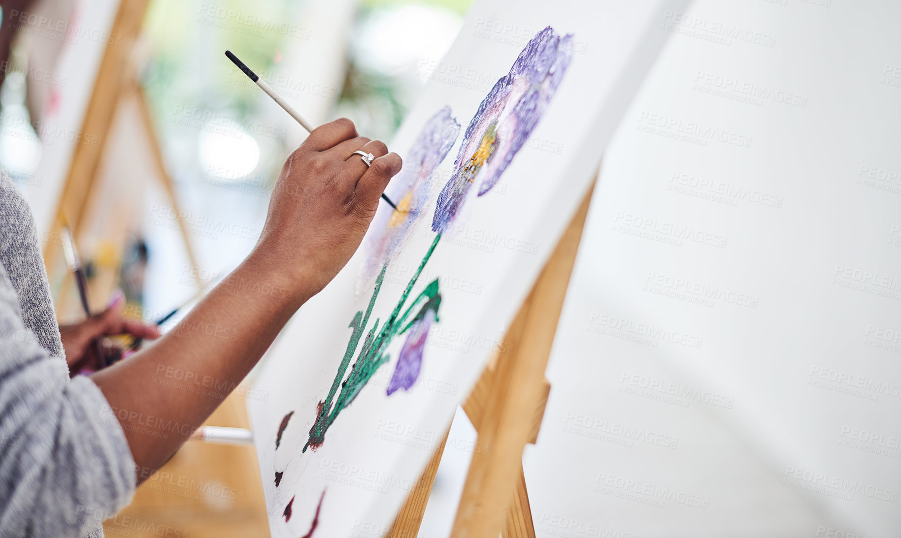 Buy stock photo Cropped shot of an unrecognizable woman working on a painting in a art studio