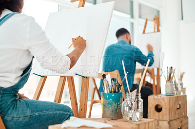 Buy stock photo Cropped shot of two unrecognizable artists sitting and sketching on a canvas during a painting session in an art studio