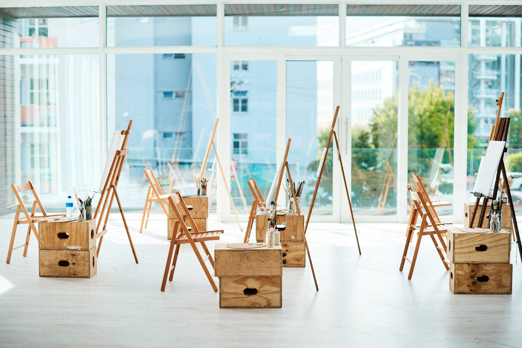 Buy stock photo Cropped shot of a group of easels and canvases in an empty art studio before a painting class