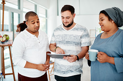 Buy stock photo Cropped shot of a diverse group of friends standing together and using a tablet during an art class