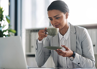 Buy stock photo Cropped shot of an attractive young businesswoman drinking coffee while working in her office