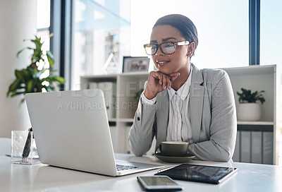 Buy stock photo Cropped shot of an attractive young businesswoman working on a laptop inside her office