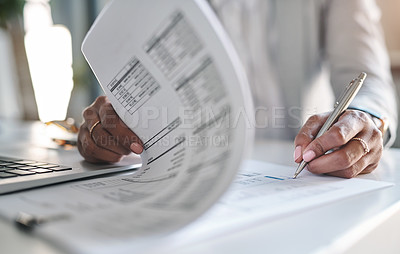 Buy stock photo Cropped shot of an unrecognizable businesswoman filling out paperwork in her office