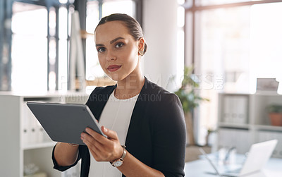 Buy stock photo Portrait of an attractive young businesswoman using a digital tablet inside her office